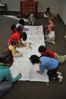 children working on a poster